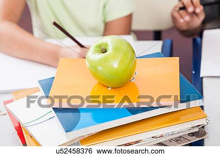 Stock Photograph - apple on books . Fotosearch