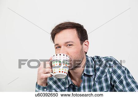 Stock Image - Beauty man drinking a coffee. Fotosearch