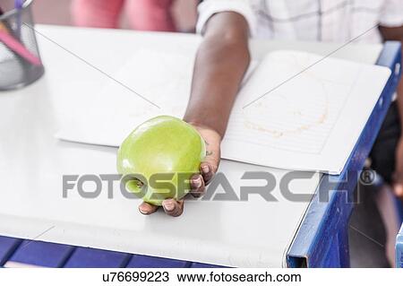 Black boy sharing a green apple View Large Photo Image Stock Image - Black boy sharing a green apple. Fotosearch