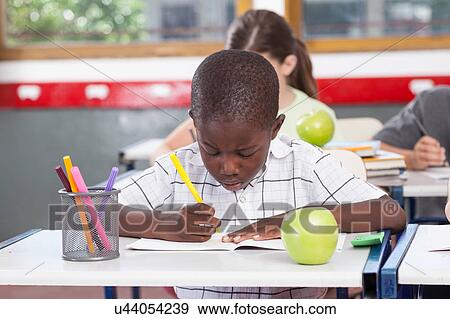 Black boy writing View Large Photo Image Stock Photo - Black boy writing. Fotosearch