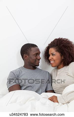 Black couple looking each other View Large Photo Image Stock Image - Black couple looking each other. Fotosearch