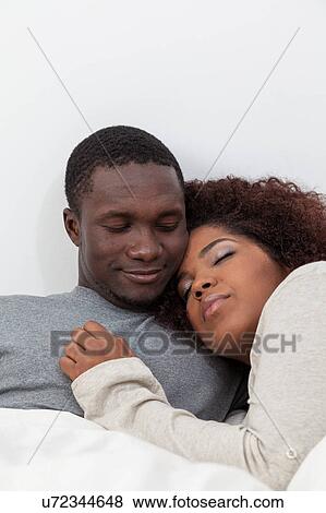 Stock Photo - Black couple sleeping. Fotosearch