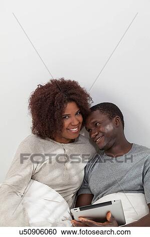 Black couple using the ipad View Large Photo Image Stock Image - Black couple using the ipad. Fotosearch