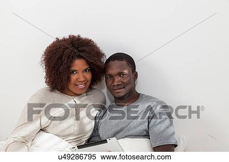 Stock Photography - Black couple using the ipad. Fotosearch