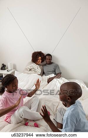 Picture - Black family in the bed. Fotosearch