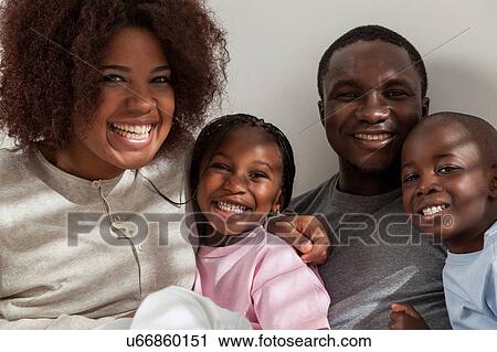Stock Image - Black family in the bed. Fotosearch