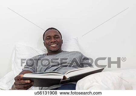Black man reading a book View Large Photo Image Stock Photo - Black man reading a book. Fotosearch