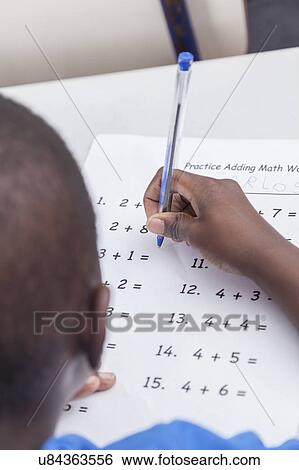 Stock Photograph - Boy doing the activity of math. Fotosearch