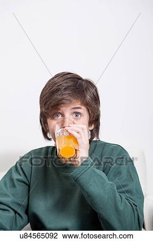 Boy drinking a oranje juice View Large Photo Image Stock Image - Boy drinking a oranje juice. Fotosearch