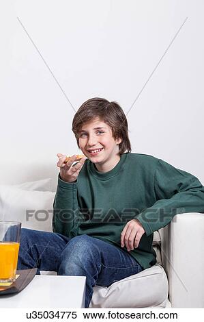 Stock Photography - Boy eating a toast. Fotosearch