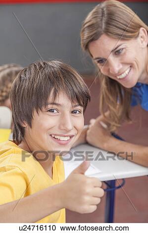 Stock Image - Boy finger up in the school. Fotosearch