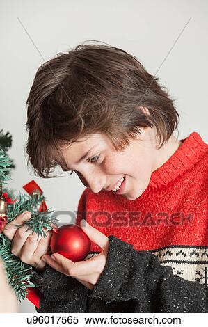 Boy holding a ball of the christmas tree View Large Photo Image Stock Photography - Boy holding a ball of the christmas tree. Fotosearch