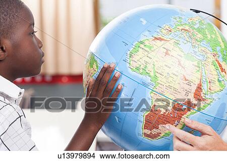 Boy learning geography View Large Photo Image Picture - Boy learning geography. Fotosearch