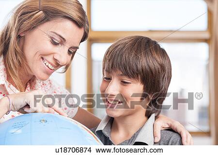Picture - boy learning geography. Fotosearch
