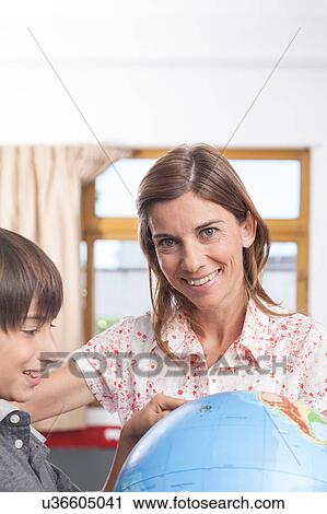 Stock Image - boy learning geography. Fotosearch