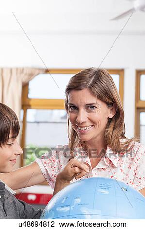 Stock Image - boy learning geography. Fotosearch