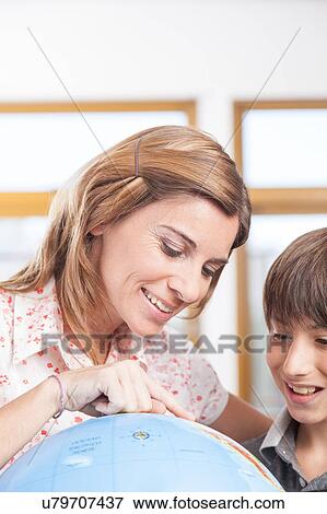 Stock Photo - boy learning geography. Fotosearch