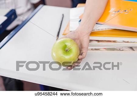Boy offering a green apple View Large Photo Image Picture - Boy offering a green apple . Fotosearch