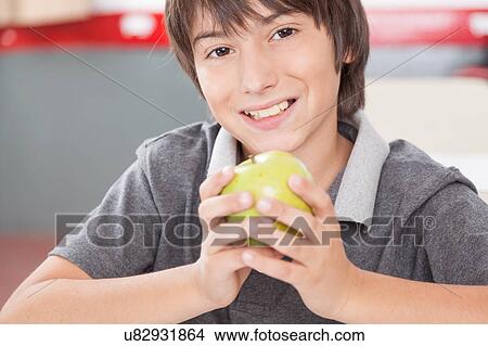 Picture - Boy sharing a apple. Fotosearch