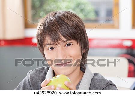 Stock Image - Boy sharing a apple. Fotosearch