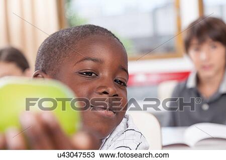 Boy sharing a apple View Large Photo Image Stock Image - Boy sharing a apple. Fotosearch