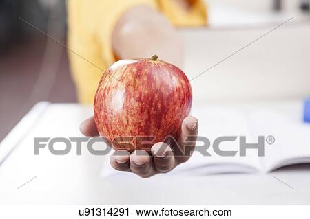 Boy showing an apple View Large Photo Image Stock Image - Boy showing an apple. Fotosearch