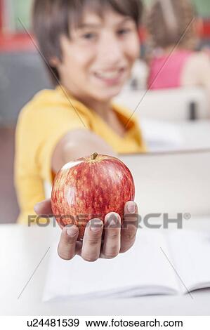 Boy showing an apple View Large Photo Image Stock Photo - Boy showing an apple. Fotosearch