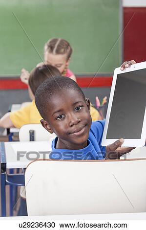 Stock Image - Boy showing the tablet. Fotosearch