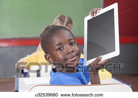 Stock Image - Boy showing the tablet. Fotosearch