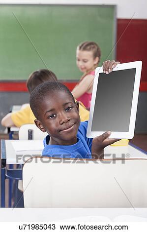 Boy showing the tablet View Large Photo Image Stock Image - Boy showing the tablet. Fotosearch