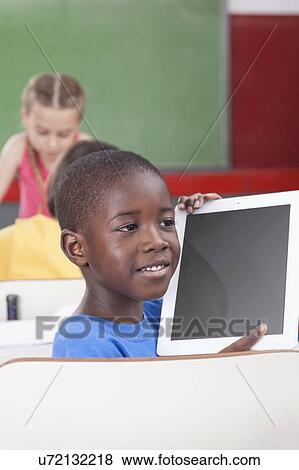 Boy showing the tablet View Large Photo Image Stock Photo - Boy showing the tablet. Fotosearch