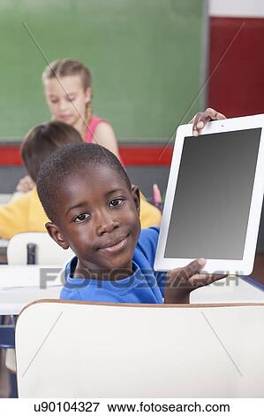 Boy showing the tablet View Large Photo Image Stock Photo - Boy showing the tablet. Fotosearch