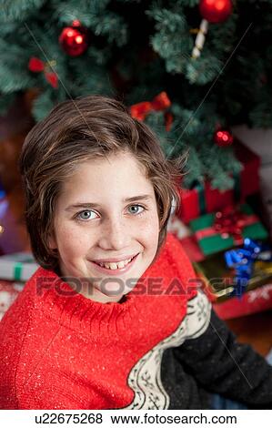Boy sitting opening the giftbox for christmas View Large Photo Image Stock Photo - Boy sitting opening the giftbox for christmas. Fotosearch