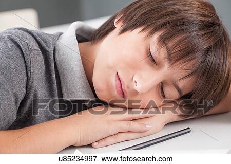 Stock Photo - boy sleeping in class. Fotosearch