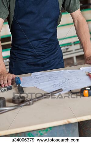 Stock Photo - Carpenter in his desk. Fotosearch