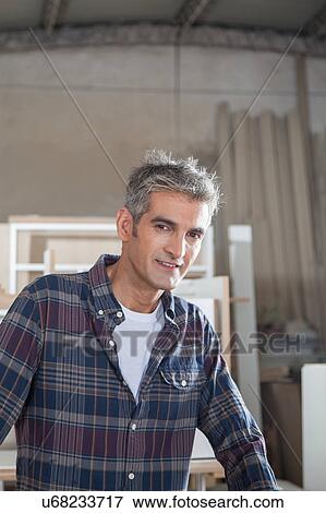 Stock Photo - Carpenter in his workshop. Fotosearch
