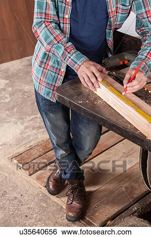 Carpenter measuring View Large Photo Image Stock Photograph - Carpenter measuring. Fotosearch