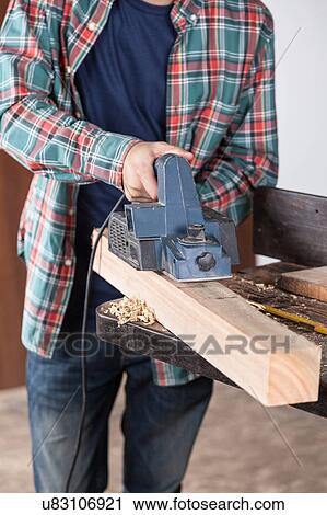 Stock Image - Carpenter with a sander. Fotosearch