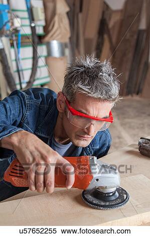 Carpenter with a sander View Large Photo Image Stock Photography - Carpenter with a sander . Fotosearch