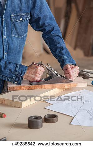 Carpenter working in his workshop View Large Photo Image Stock Image - Carpenter working in his workshop. Fotosearch