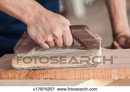 Stock Photo - Carpenter working in his workshop. Fotosearch