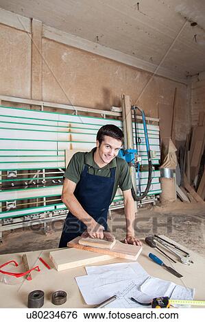 Stock Photograph - Carpenter working in his workshop. Fotosearch