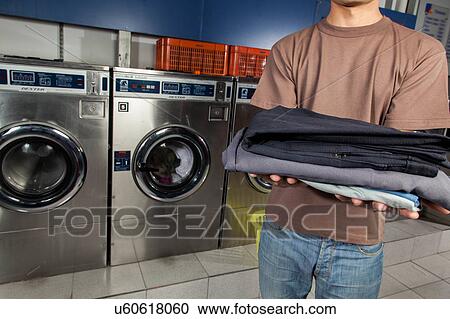 Stock Image - Clothes on your hands in the laundry. Fotosearch