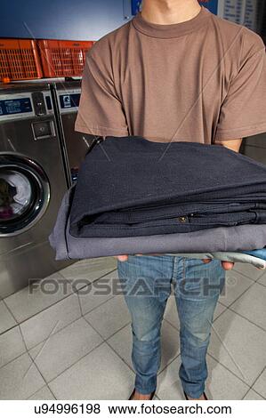 Stock Photo - Clothes on your hands in the laundry. Fotosearch