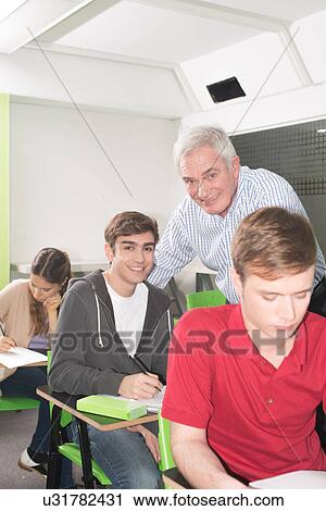 College teacher helps his students View Large Photo Image Stock Image - College teacher helps his students. Fotosearch