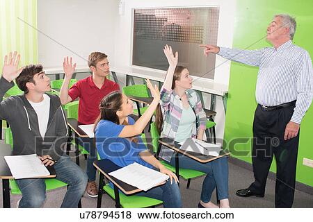College teacher helps his students View Large Photo Image Stock Photo - College teacher helps his students. Fotosearch