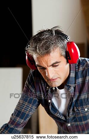 Stock Photography - Concentrated man with headphones . Fotosearch