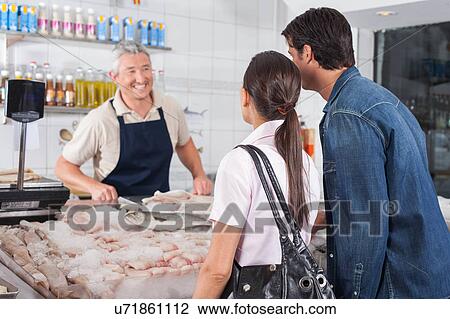 Couple buying fish View Large Photo Image Stock Image - Couple buying fish. Fotosearch