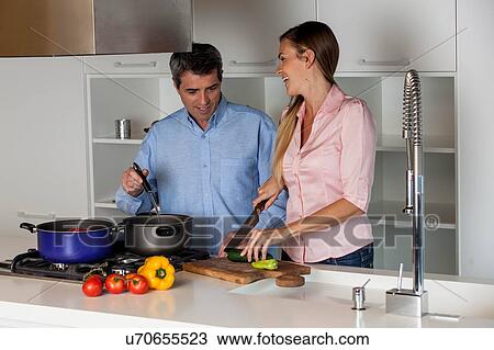 Stock Image - couple cooking in the kitchen. Fotosearch