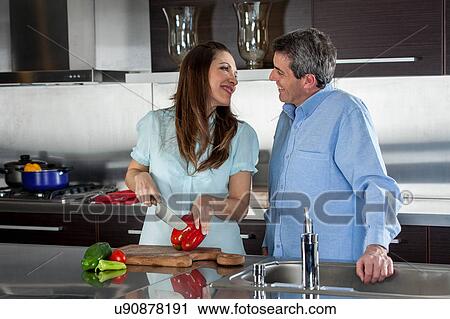 Stock Image - couple cooking in the kitchen. Fotosearch
